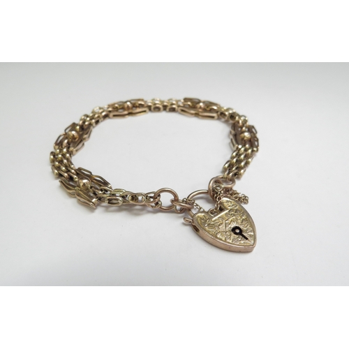 9035 - A 9ct gold smooth and textured link bracelet with padlock clasp, 9g