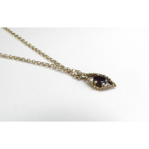 9071 - A 9ct gold chain, 52cm long hung with a 9ct gold garnet pendant, 4.6g