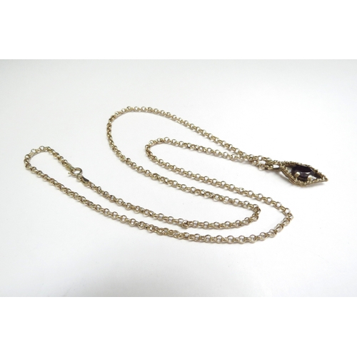 9071 - A 9ct gold chain, 52cm long hung with a 9ct gold garnet pendant, 4.6g