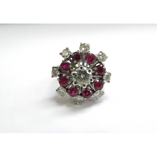 9006 - A ruby and diamond cocktail ring, the centre diamond 0.75ct approx surrounded by eight rubies and ei... 