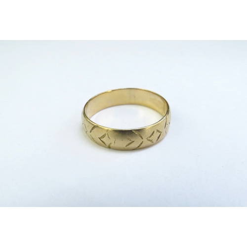 9101 - An 18ct gold band with etched decoration. Size Q, 3.4g