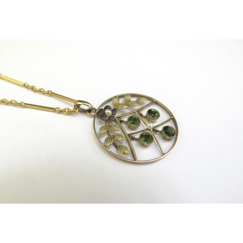 9045 - A gold circular pendant with four green droplets stamped 9ct hung on a gold chain stamped 15ct, 40cm... 