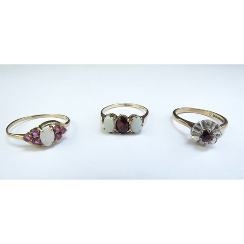 9103 - Three 9ct gold rings including opal and garnet, opal and ruby and diamond and red stone examples, 5.... 