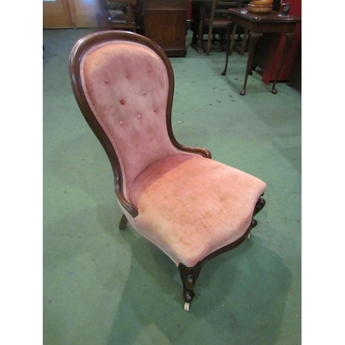 4015 - An early Victorian mahogany spoon back salmon pink upholstered armchair, the button back rest over a... 