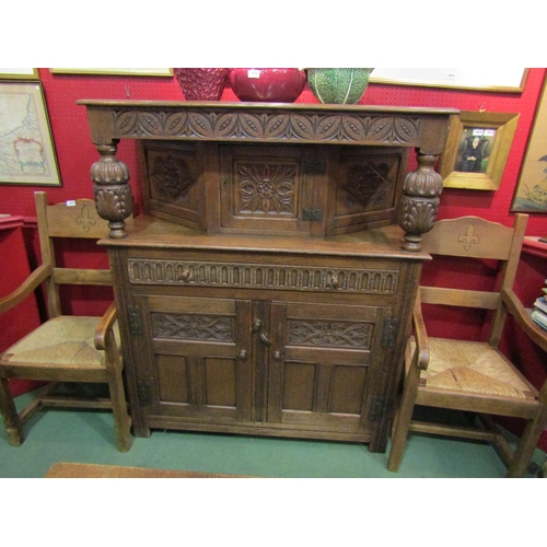 4043 - An Old Charm style oak court cupboard with carved detailing, single cupboard top door over single dr... 