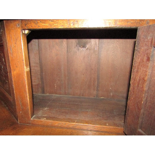 4043 - An Old Charm style oak court cupboard with carved detailing, single cupboard top door over single dr... 