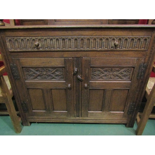 4043 - An Old Charm style oak court cupboard with carved detailing, single cupboard top door over single dr... 