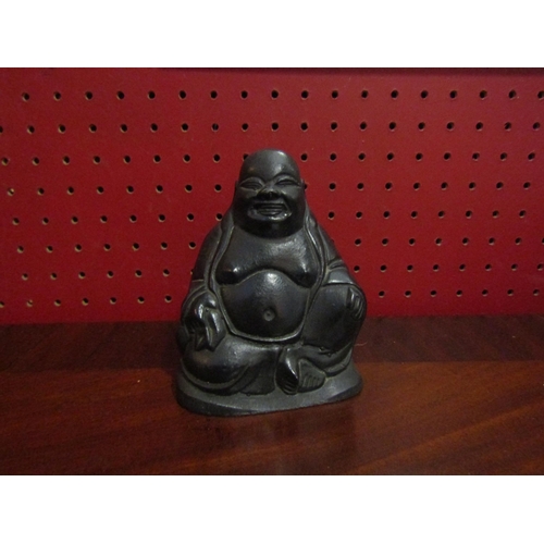 4063 - A seated laughing Buddha, 10cm tall