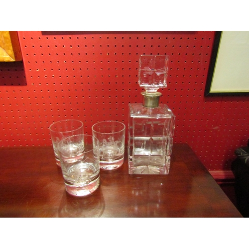 4067 - A crystal glass square form decanter with silver collar and three tumblers