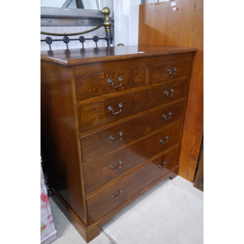 2331 - A Georgian reproduction oak chest of two short over four long drawers, bracket feet