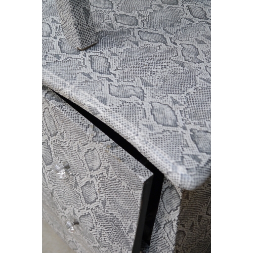 2343 - A two drawer snake skin chest with a side table