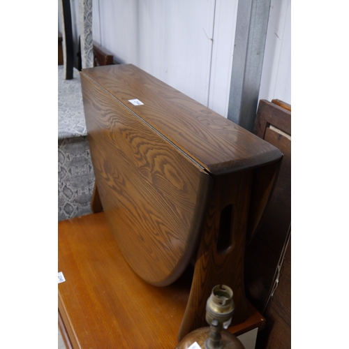 2344 - A small Ercol oak drop-flat coffee table