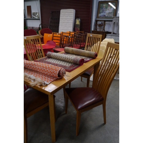 2358 - A light oak kitchen table with four matching slat-back chairs