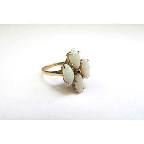 9133 - A 9ct gold four stone opal and small ruby set ring. Size M, 2.7g