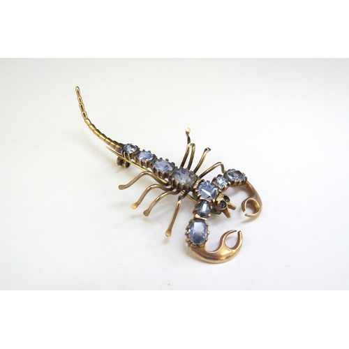 9210 - A gold scorpion brooch with pale blue sapphire set body, unmarked, 6.2g