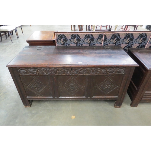 2203 - An 18th Century heavily carved oak three panel coffer  135cm (w)
66cm (h)
55cm (d)