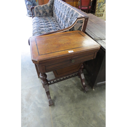 2205 - A 19th Century mahogany games table with fold over swivel top