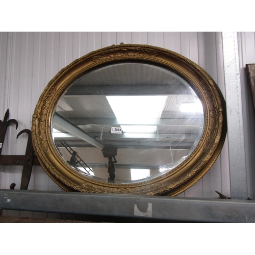 2084 - An oval gilt framed wall mirror