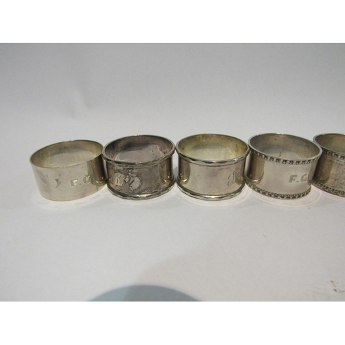 4311 - Three pairs of silver napkin rings and two singular examples (8)