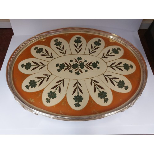 4463 - A silver plated footed tray with gallery edge inset with ceramic base decorated with flowers on a cr... 