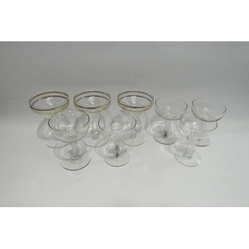 4447 - Eight champagne saucers including four with hollow stems and three with gilt borders and etched wave... 