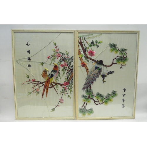 4451 - Five Oriental silk embroideries depicting birds amongst flowering trees, a/f two with cracked glass ... 