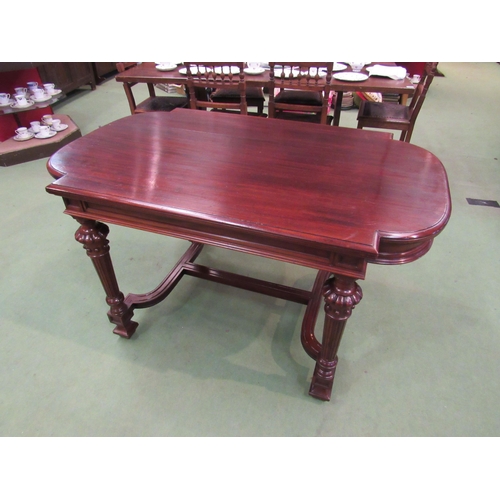 4098 - A mid Victorian mahogany library centre table, the breakfront top on turned and reeded legs with flu... 