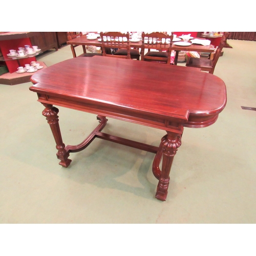 4098 - A mid Victorian mahogany library centre table, the breakfront top on turned and reeded legs with flu... 