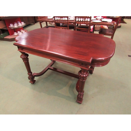 4098 - A mid Victorian mahogany library centre table, the breakfront top on turned and reeded legs with flu... 