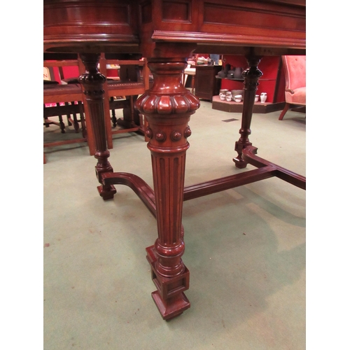 4098 - A mid Victorian mahogany library centre table, the breakfront top on turned and reeded legs with flu... 