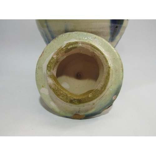 4264 - A French pottery jar with twin handles and lid dribble glaze, 26cm tall