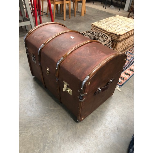 2381 - A polished early 20th Century dome top storage trunk