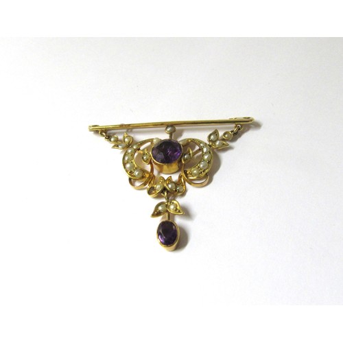 9377 - A gold bar brooch stamped 9ct suspended with a scroll and swag seed pearl and amethyst panel and ame... 