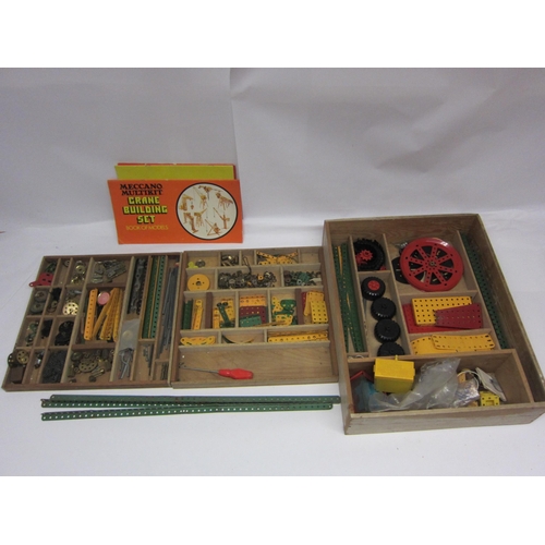 8359 - A wooden storage box of mixed Meccano components including girder plates and strips, wheels, brass g... 