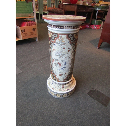 1004 - A Victorian pottery jardiniere stand with floral design, 69cm tall