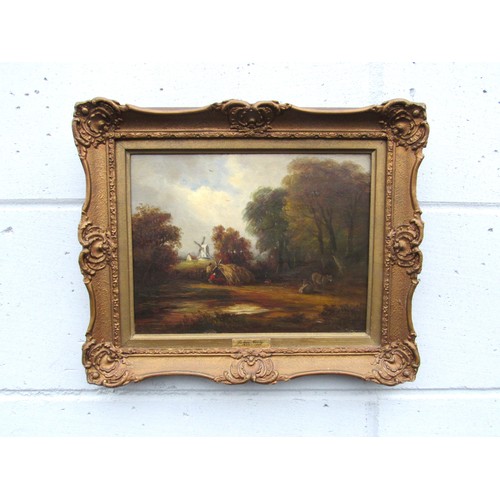 6068 - JOHN MOORE OF IPSWICH (1820-1902) An ornate gilt framed oil on wooden board, rural scene with windmi... 