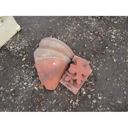 3340 - A quantity terracotta hip tiles etc