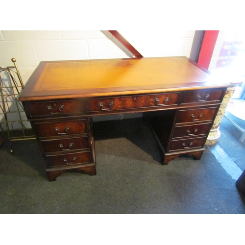 1008 - A reproduction mahogany twin pedestal desk on bracket feet, eight drawers, gilt tooled leather inser... 