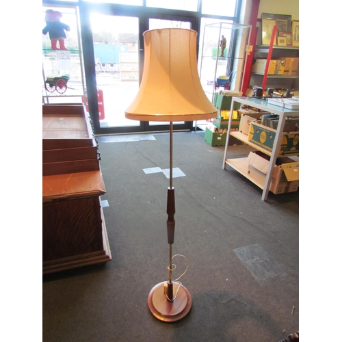 1010 - A retro 1960's teak and metal standard lamp with shade