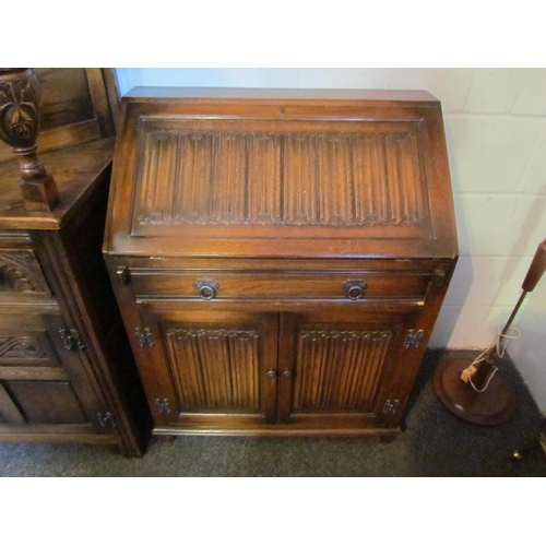 1012 - An Old Charm style oak bureau, linen-fold detail, 98cm tall x 77cm wide x 42cm deep