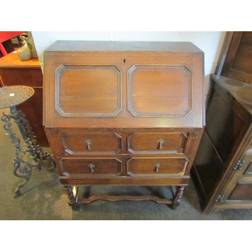 1021 - An early 20th Century geometric oak bureau, two drawers on stretcher base, some moulding missing, 10... 