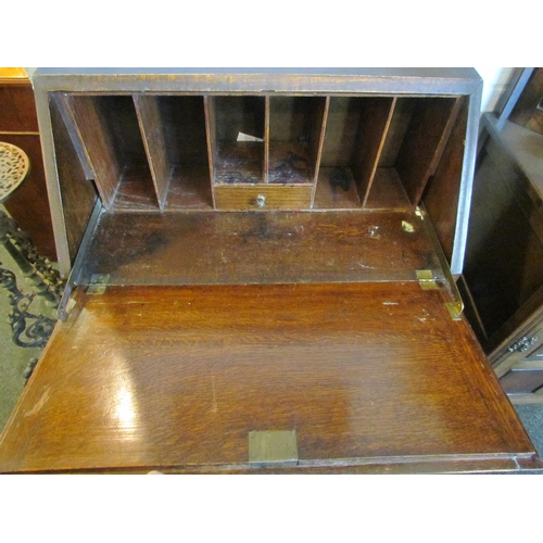 1021 - An early 20th Century geometric oak bureau, two drawers on stretcher base, some moulding missing, 10... 