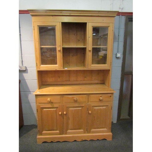 1042 - A modern pine dresser with cupboard and shelf top over three drawer, three door base, 198cm tall x 1... 