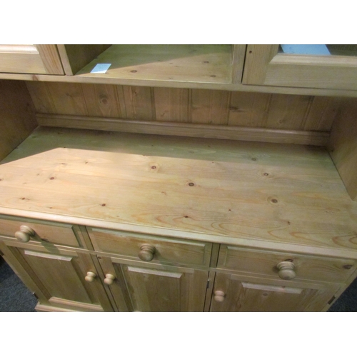 1042 - A modern pine dresser with cupboard and shelf top over three drawer, three door base, 198cm tall x 1... 