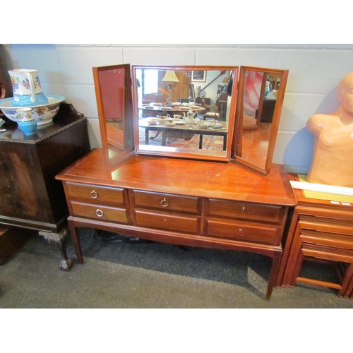 1075 - A Stag Minstrel dressing table with raised mirror back, 128cm tall x 130cm wide x 46cm deep