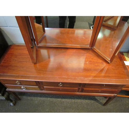 1075 - A Stag Minstrel dressing table with raised mirror back, 128cm tall x 130cm wide x 46cm deep