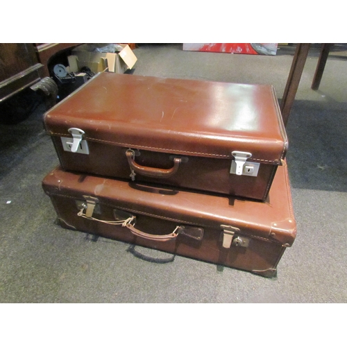 1083 - Two bygone suitcases, graduated in size, one labelled Pioneer Luggage, both with keys