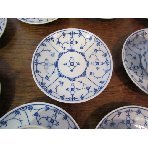 1087 - A set of blue and white German coffee cups and saucers in the onion pattern style, 11 cups and 12 sa... 