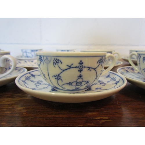 1087 - A set of blue and white German coffee cups and saucers in the onion pattern style, 11 cups and 12 sa... 