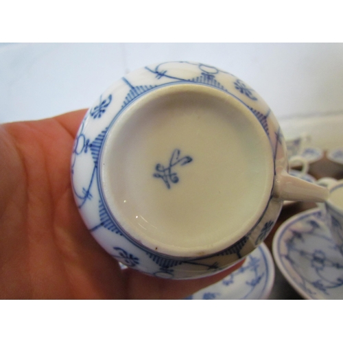 1087 - A set of blue and white German coffee cups and saucers in the onion pattern style, 11 cups and 12 sa... 